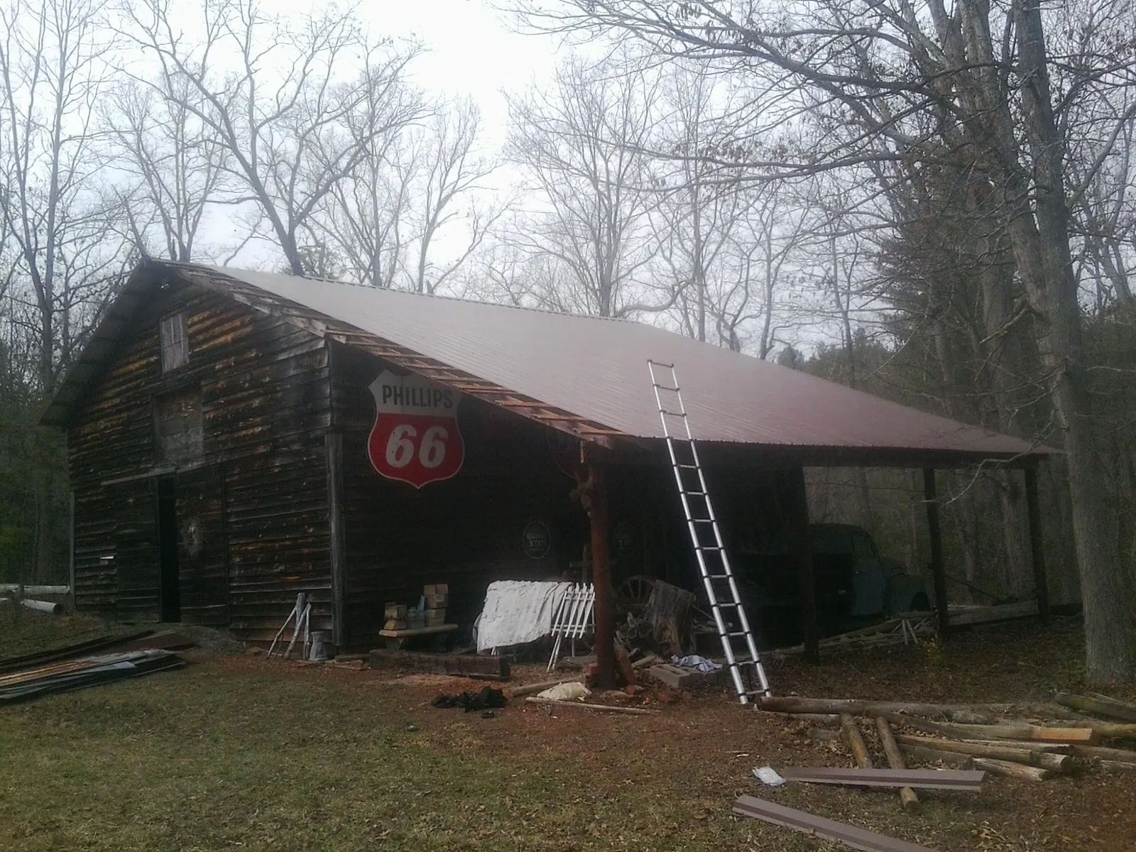 New metal roof on an open sided timber barn with a vintage sign in Viola